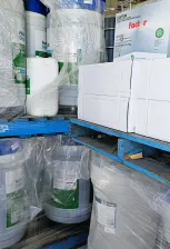 A Towering Pile Of Plastic Containers Alongside Various Other Items Stacked Together